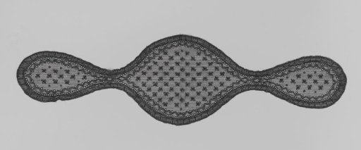 Fanchon of black machine lace with scattered clover leaves