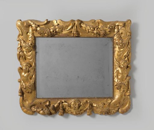 Mirror frame of gilded walnut, richly carved with scrollwork and floral garlands, bird motifs, tassels and putti