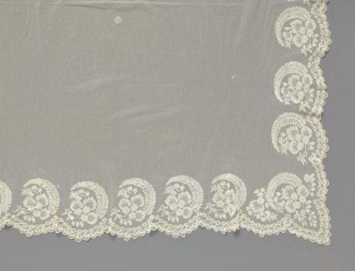 Bridal veil of lace embroidery on tulle with border pattern of flower sprays and feathers