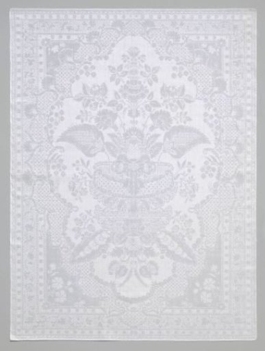 Napkin with flower vase surrounded by lace pattern