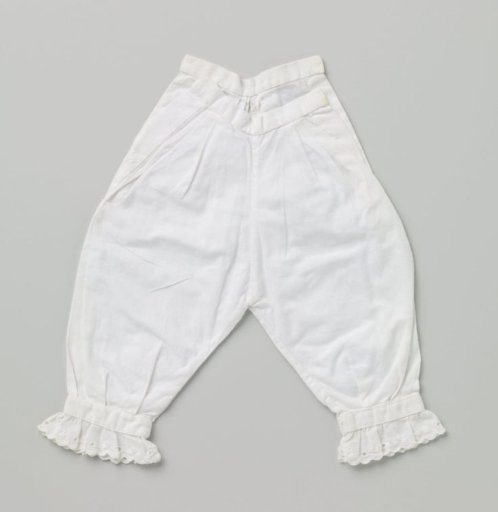 Trousers for a baby with gathered applied scalloped lace trim at the legs