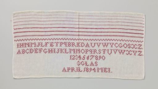 Linen sampler with a grid of red letters and numbers, marked: 'G. Glas April 1894 May'