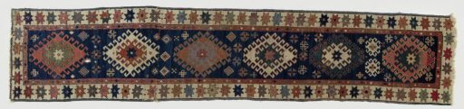 Medallion or lozenge medallion carpet: six lozenges with crochet contours filled with straw. Double border with stars and lozenges.