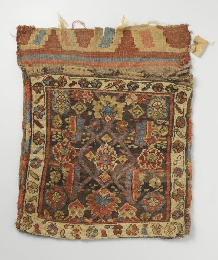 Saddlebag, decorated with crossed vines and leaves and four rosette flowers