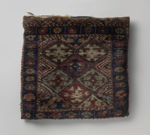 Front panel of a saddlebag, decorated with lattice work within which are cross-flowers