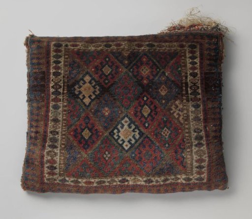 Front panel of a saddlebag, decorated with lattice work within which are cross-flowers