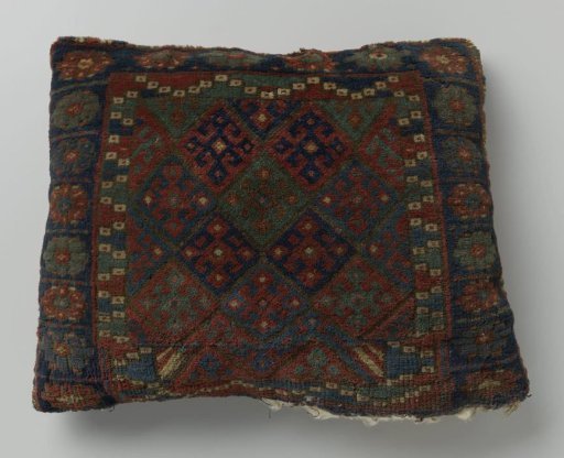 Cushion or bag, with lattice design, divided into squares with hooked cross flower.
