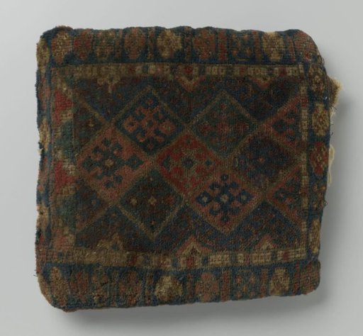 Cushion or bag with lattice divided into squares and hooked cross flowers. Back flat woven in broad stripes.