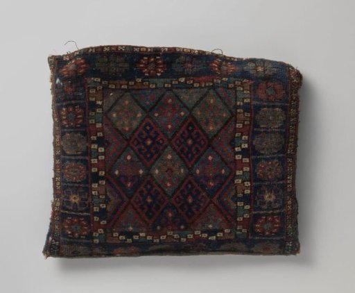 Cover of a saddlebag decorated with a grid pattern; triple border with rosette flowers
