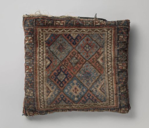 Front cover of saddlebag decorated with diamonds; outer border with rectangles and rosette flowers