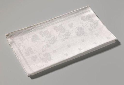 Tablecloth of white linen damask with grape pattern