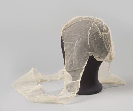 Tulle cap consisting of a crown trimmed with a strip of tulle flowing into chin straps