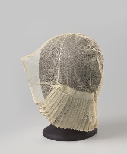 Tulle cap consisting of a crown trimmed along the forehead with a pleated strip of tulle