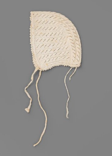 Cap for day or underdress of knitted cotton; cable pattern