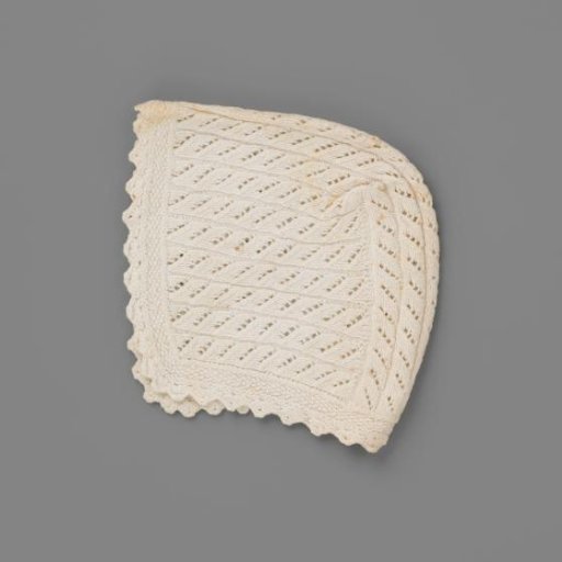 Cap for day or underdress of knitted cotton; cable pattern
