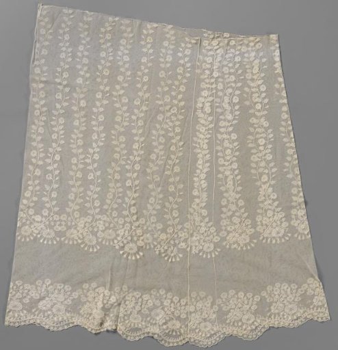 Skirt of a dress with lace embroidery on machine-made tulle featuring wavy standing rose stems