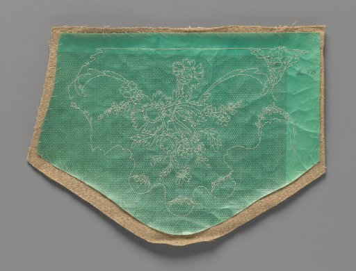 Tools for a needle lace motif in the form of tailor's linen with green parchment sewn on with white tracing threads in the form of a bouquet of flowers for a short sleeve