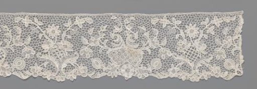 Strip of needle lace with flower vase in which branches form a V and a kidney-shaped cartouche