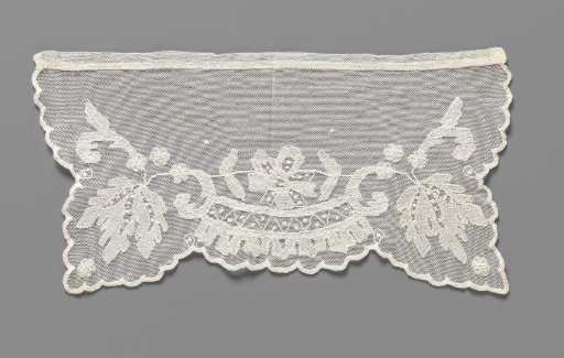 Cuff of lace embroidery with a symmetrical pattern of a rose above a decorative band with a zigzag and godrons