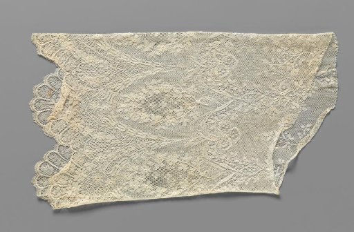 Sleeve of machine-made lace with pointed oval medallions for an evening gown