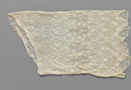 Sleeve of machine-made lace with pointed oval medallions for an evening gown