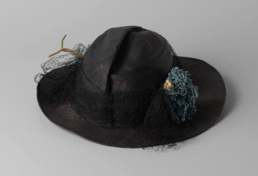 Hat of black straw overlaid with machine-made tulle
