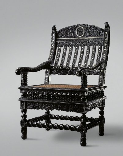 Armchair of ebony, inlaid with ivory and decorated with Nereids, flowers and birds, armrests supported by a figure of a European soldier, back with oval coat of arms: Child