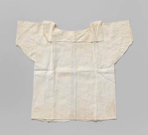 Children's shirt of fine white linen with a straight flat collar, neck opening and short sleeves; marked in pink cross-stitch: DCM12