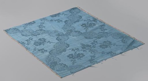 Fragments of blue silk damask with a floral pattern