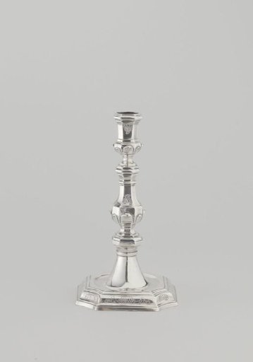 Silver candlestick with octagonal foot and octagonal baluster-shaped stem with candle holder. Engraved with rocaille motifs.