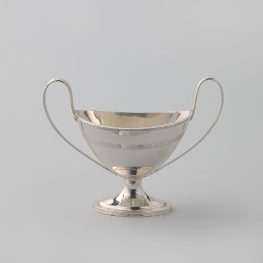 Silver sugar vase, oval on an arched foot with two high handles. Decorated with filigree borders.