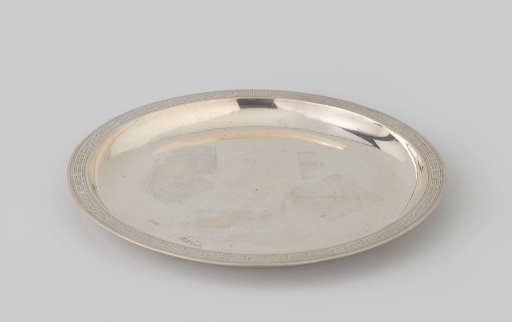 Silver presentation plate, round, with broad flat rim, decorated with meanders