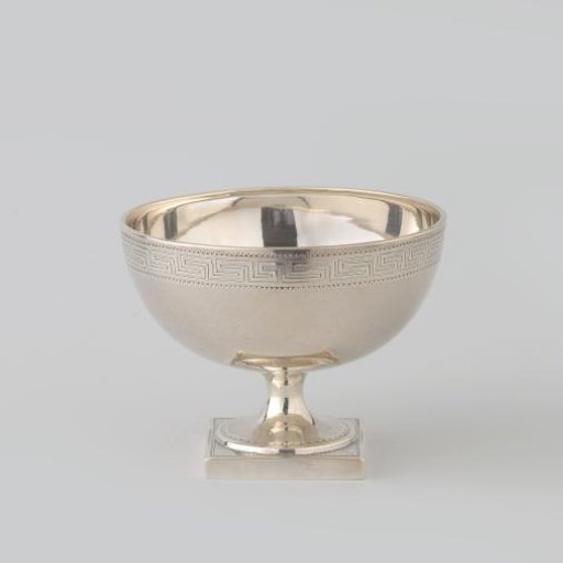 Silver bowl on a square, straight-walled base. Decorated with meander border