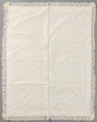 Baptismal garment of batiste with plumetis embroidery and a border of machine-made lace