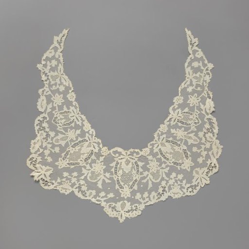 Shawl collar of applied lace with radially placed pineapple or pomegranate motifs