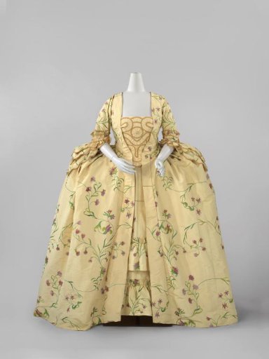 Japon of lemon-yellow ribbed silk embroidered with silk with vines and purple flowers, consisting of an overskirt (a), an apron (b), a devant-de-gorge (c) and a loose length of silk (d)