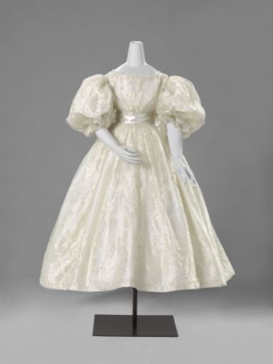 Wedding overjapon of white silk gauze with an interwoven white satin floral and border pattern, with two intertwining floral and leafy vines, originating from wavy S-scrolls