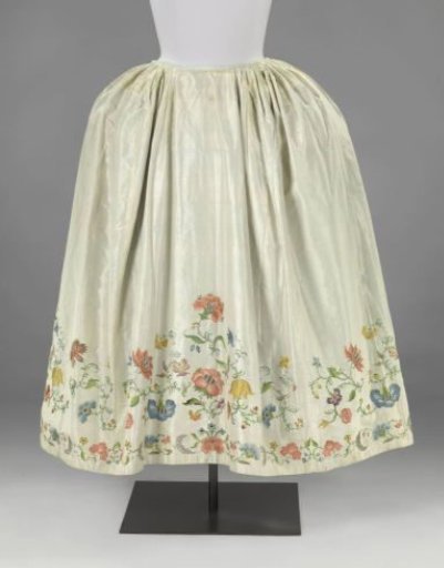 Skirt of white taffeta silk embroidered with multicoloured floral and leaf vines, lined with blue taffeta silk
