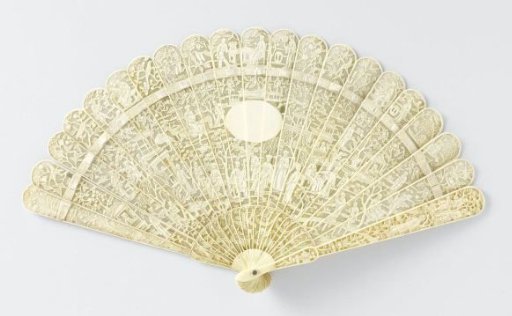 Brisé fan of pierced and carved in relief ivory depicting scenes from Chinese life with pagodas, houses, trees and in the center an unadorned oval medallion