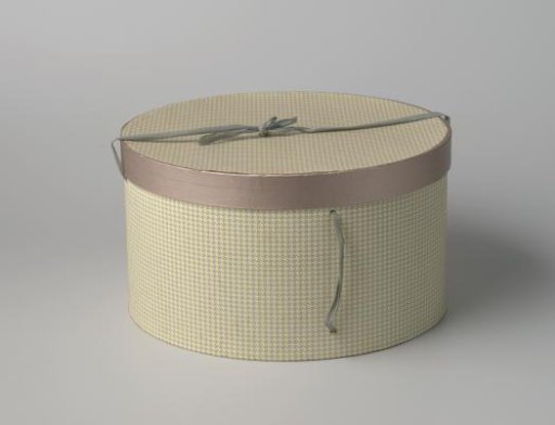 Round hatbox of cardboard, covered with paper printed with a grey pied-de-poule pattern on yellow
