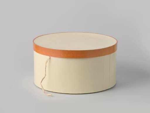 Round hatbox of cardboard covered with cream-colored paper