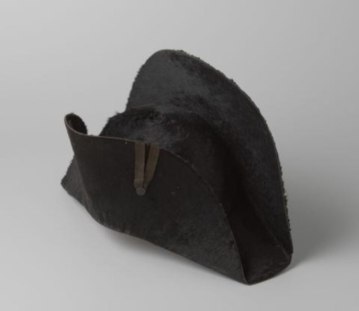 Mourning badge of black hair felt; the right leaf is decorated with a narrow bow of black ribbon, upon which a small knot covered with grosgrain ribbon
