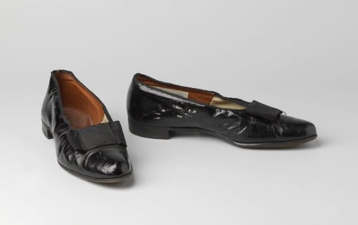 Gentlemen's glove of black lacquered leather with a bow of black grosgrain ribbon
