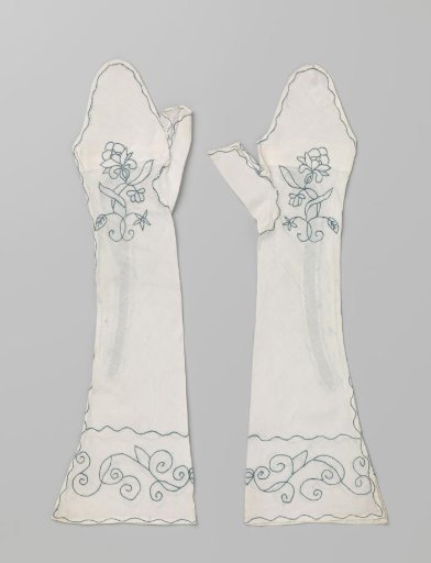 Linen gauntlet, embroidered in blue with flower sprays and branches with serpentine volutes