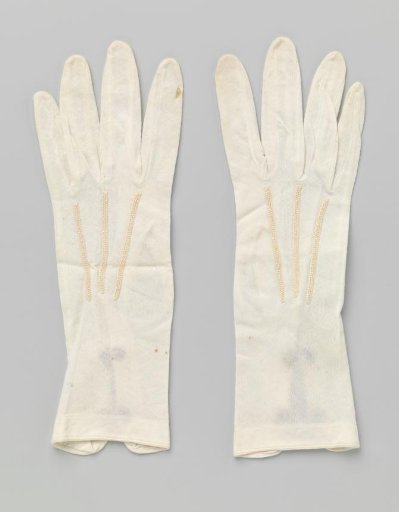 Glove of white knit fabric with a slit and two snap fasteners