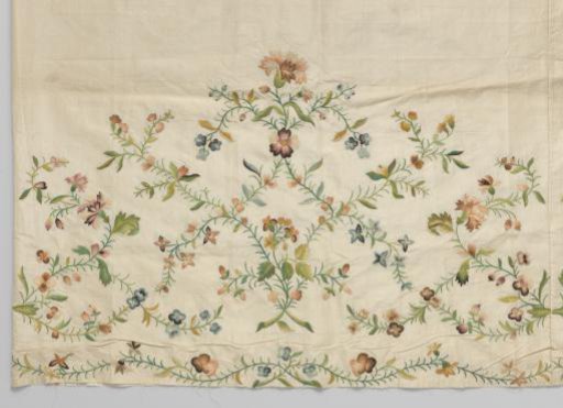 Skirt panels of white taffeta, embroidered with floral scrolls at the bottom