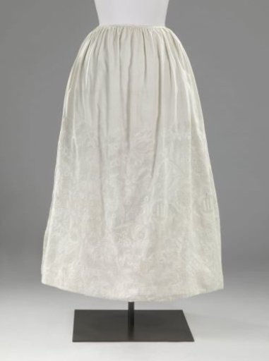 Skirt of white cotton, more than half decorated with white English embroidery featuring leaf and flower motifs and abstract designs