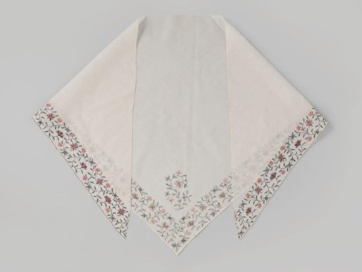 Fichu of white cotton batiste, triangular, fringed on two sides with a border of red, blue, green, and gold flowers and leaves