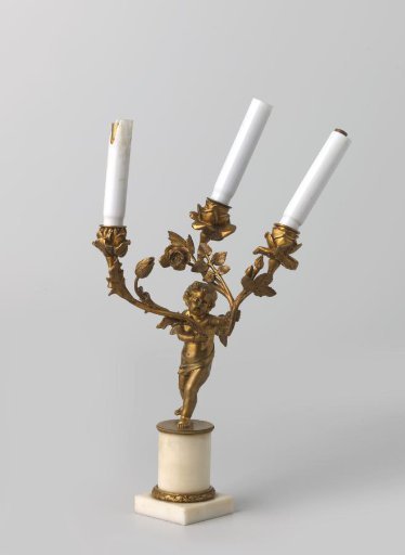 Candelabrum of white marble and gilded bronze, with three arms in the form of branches with leaves, ending in rosebuds, supported by a winged putto