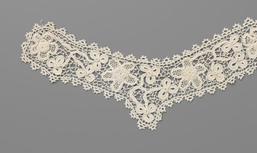 Collar of crocheted lace with clover leaves and five-petaled roses with a heart in relief